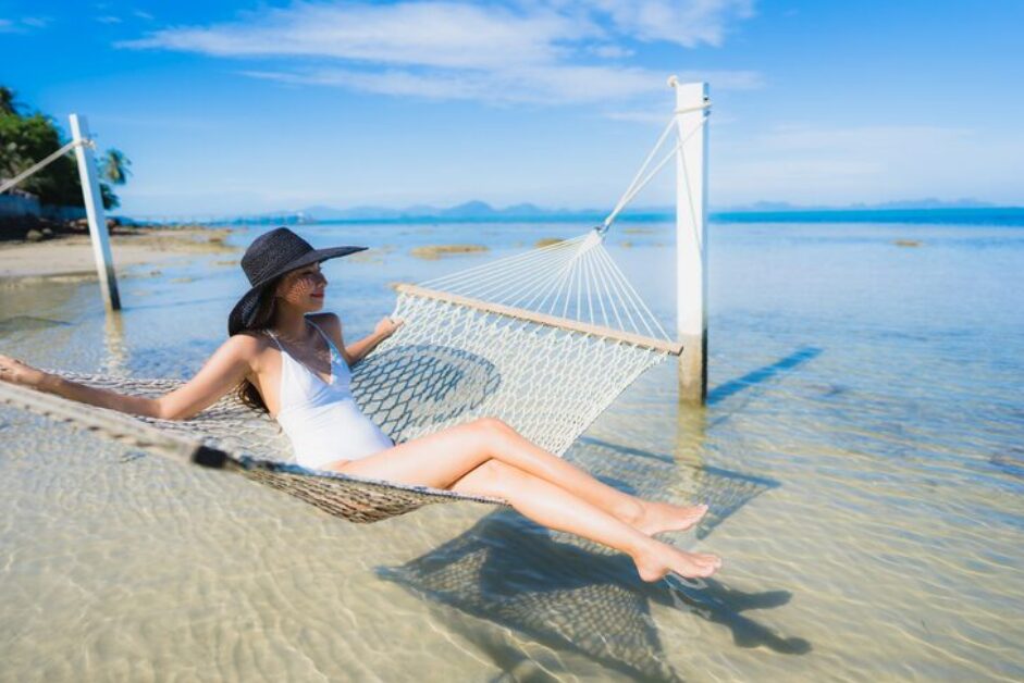Guests relaxing at a beachfront resort pool overlooking the ocean, illustrating leisure things to do in Cam Ranh.