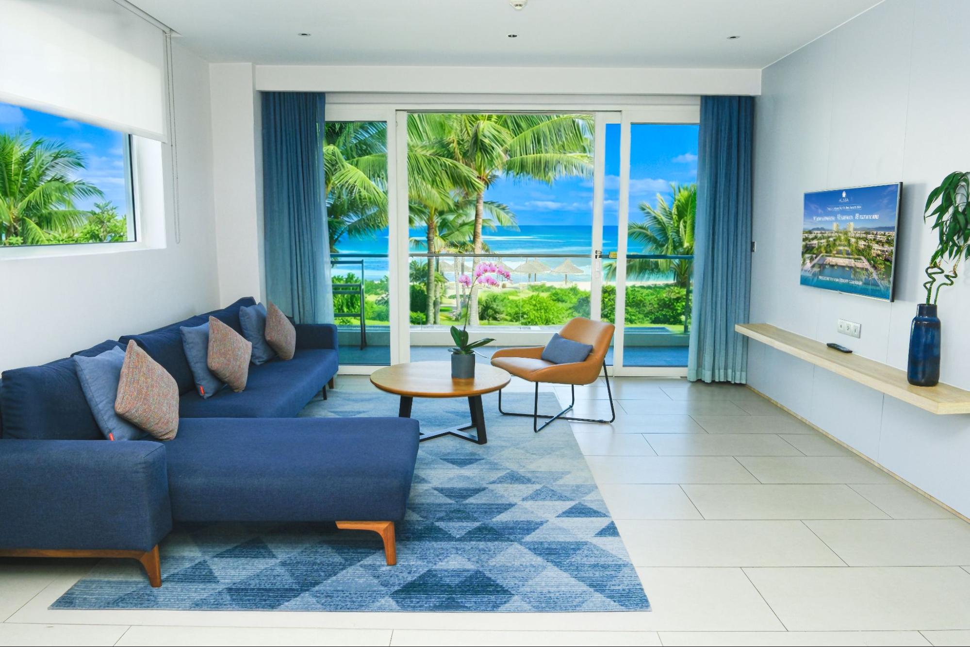 Elegant villa living room with floor-to-ceiling windows and sea views, reflecting the style of villas in Cam Ranh.