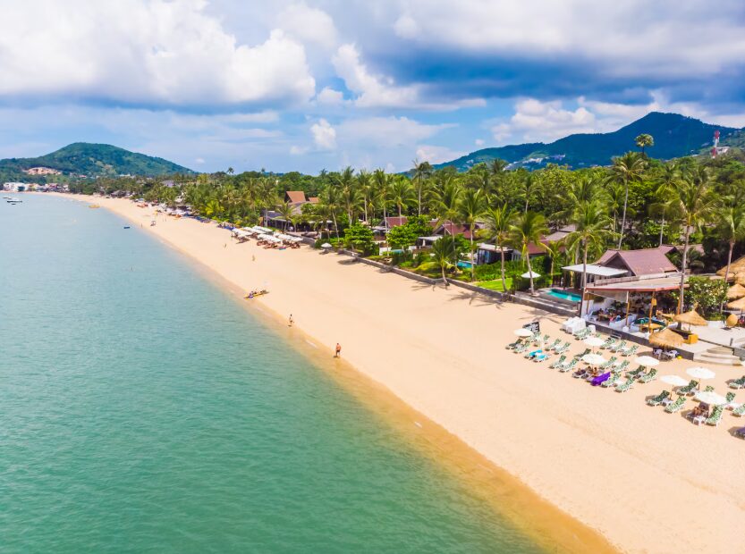 Pristine white sand shoreline with turquoise water at Bai Dai, showcasing the natural beauty of Cam Ranh beaches.