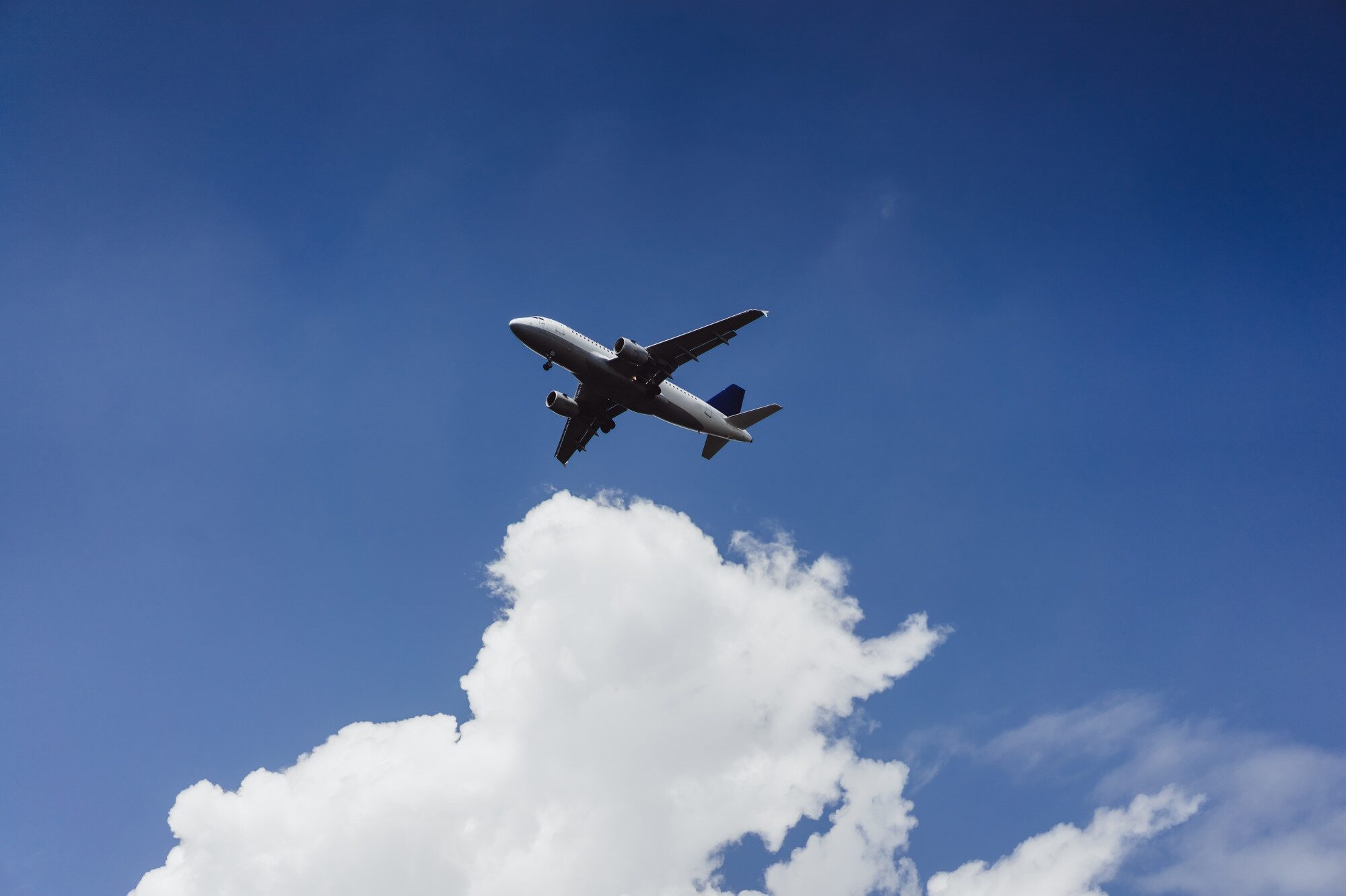 Airplane landing at Cam Ranh International Airport with coastal views, illustrating how to get to Cam Ranh by air.